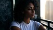 © CreativeArt - Young woman exhaling a stream of smoke or vapor while observing the blurred urban skyline from a balcony, reflecting a moment of quiet contemplation and relaxation in a city setting
