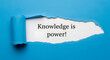 © Different Design - Blue paper torn revealing white background with text Knowledge is power image
