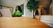 © Jacob Lund - Her workday shows a work routine with phone and laptop at the office desk