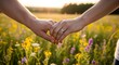 © Rendah - Tender Couple Holding Hands in Sunlit Wildflower Meadow