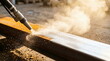 © CK Studio - Sandblasting surface preparation removing rust from steel beam in industrial environment, metal restoration and construction maintenance.