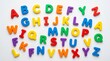 © Gophotograph - Educational alphabet magnets in bright colors lying on a white background.