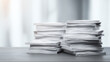 © Idea Stock - A chaotic stack of paper documents on a desk, symbolizing disorganization and the need for efficient document management.