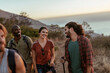 © Marko Geber - Friends hiking on a coastal trail at sunset