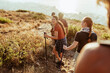© Marko Geber - Friends hiking on coastal mountain trail at sunset