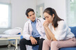 © amnaj - Doctor listening empathetically and offering support to a crying female patient in a healthcare setting, discussing mental health