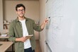 © Asier - Young man brainstorming ideas on whiteboard during education presentation