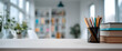 © MDRAFIQUL - Organized workspace featuring pencil holder with pens and stack of books on wooden table.