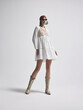 © Cumhur - Boho Luxury Editorial: Confident Front Pose in White Tiered Mini Dress and Gold Western Boots