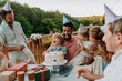 © Halfpoint - Multi generation family celebrating birthday on terrace.