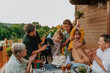 © Halfpoint - Multi generation family celebrating birthday and have garden party outside in the backyard on patio.
