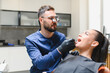 © Serhii - Dentist examining patient's teeth during dental checkup