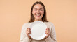 ©  Kibria Islam - Woman smiling holds an empty white ceramic plate as a food service product mockup concept.