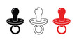 © abdul - Close-up of a baby pacifier with a black, white, and red color scheme and a round handle for soothing infants