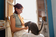 © Alberto/Stocksy - Woman Enjoying a Cozy Moment With Her Cat Indoors