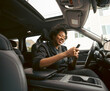 © Artcore Studio/Stocksy - Woman using phone in car interior