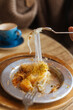 © Pietro Karras/Stocksy - Cheese-filled kÃ¼nefe dessert being served with fork
