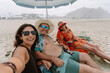 © Luis Herrera/Stocksy - happy Family Taking a Selfie on Beach