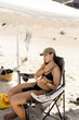© Almu Zambrana/Stocksy - UGC woman applying sunscreen under sun shelter in Australia