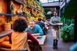 © Daniel Gonzalez/Stocksy - People enjoying themselves in a green restaurant bar