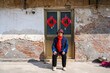 © Yic Ma/Stocksy - Elderly woman sitting at doorway
