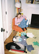 © Raymond Forbes LLC/Stocksy - UGC Girl Portrait in messy room working  Ipad tablet computer