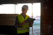 © Artcore Studio/Stocksy - Worker with tablet on site at sunset