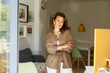 © valbar STUDIO/Stocksy - Woman Stands in Room With Natural Light While Crossing Arms