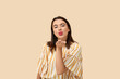 © Pixel-Shot - Beautiful young happy woman blowing kiss on beige background