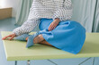 © Asya Molochkova/Stocksy - Minimal fashion detail with polka dot blouse and blue skirt