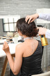 © Pixel-Shot - Professional hairdresser applying hair spray on young woman's hair in beauty salon