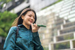 © Art_Photo - Smiling asian business woman using AI voice assistant on smartphone outdoors, Smart agent technology, Female corporate employee recording audio message or speaking to artificial intelligence app