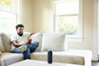 © Guille Faingold/Stocksy - Man Using Smartphone in a Cozy Home
