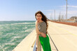© valbar STUDIO/Stocksy - Woman Stands by the Pier With Ocean Waves