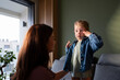 © Artcore Studio/Stocksy - Child getting dressed with parent help at home
