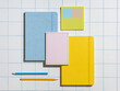 © Marc Tran/Stocksy - Flat lay of colorful stationery arranged on grid pattern