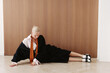 © Serge Filimonov/Stocksy - Modern fashion portrait woman lying on studio floor