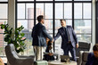 © Guille Faingold/Stocksy - handshake at Modern Office Business