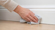 © VectorVille - Hand cleaning baseboards with rag on wooden floor indoors