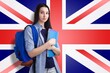 © BillionPhotos.com - Female student with backpack and notebooks standing in front of a United Kingdom flag