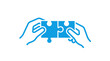 © reza - Hands connecting two puzzle pieces, symbolizing teamwork and solutions