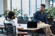 © ASDF - Two men are sitting at a desk talking