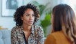 © meka - Two women in conversation, one with curly hair.