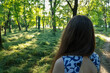 © Onyx Agency - Woman walks through a green forest area during a sunny day in the summer