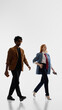 © master1305 - Stylish business pair walking in white studio. Concept of career movement, corporate confidence, modern office lifestyle, professional partnership, and executive mobility.