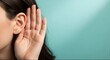© MD NAIM ISLAM - Close up of woman holding hand to ear listening closely over light blue background