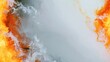 © Syarif - Fiery orange and white smoke swirls abstractly over a light grey backdrop