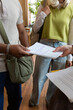 © Danil Nevsky/Stocksy - Diverse students exchanging notes in a university library