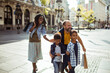 © Davor - Family shopping and riding scooter on sunny city street