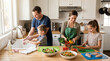 © saif - Happy family preparing a healthy dinner together in their bright modern kitchen while the father helps his young son wash hands and the mother watches her daughter chop fresh vegetables